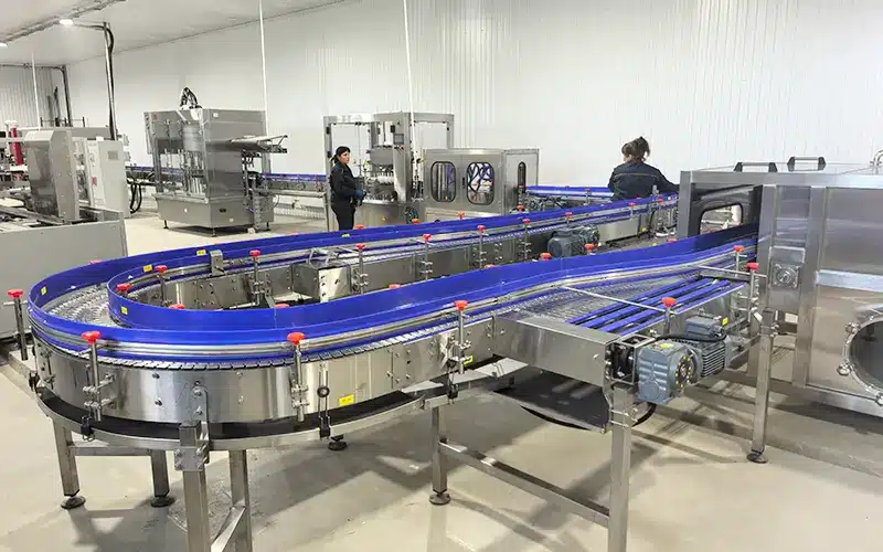 Navan turnkey beverage filling line including rinsing, filling, capping, and conveyor system.