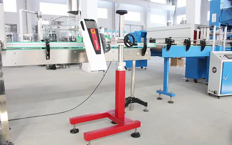 Laser printing machine marking production date and batch number on bottle caps.