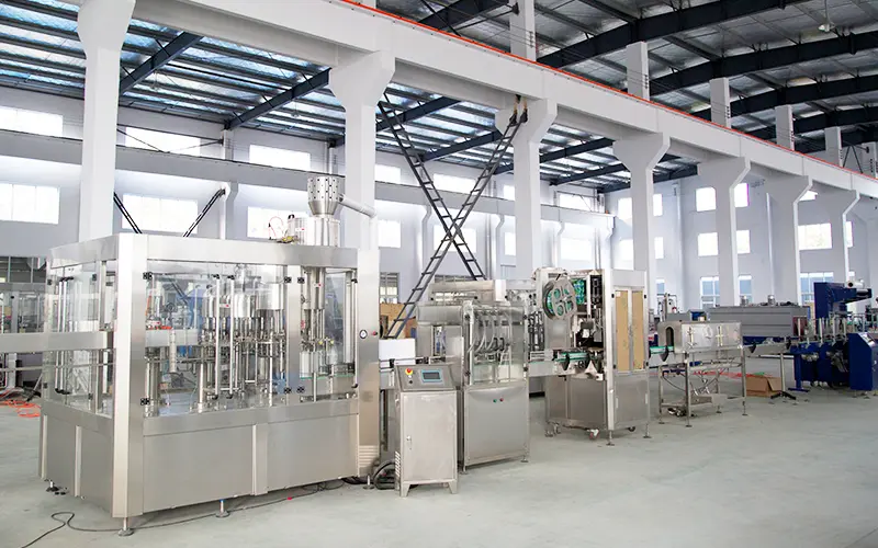 Complete water bottling plant equipment showing water tanks, filling machine, labeler, and packer in sequence